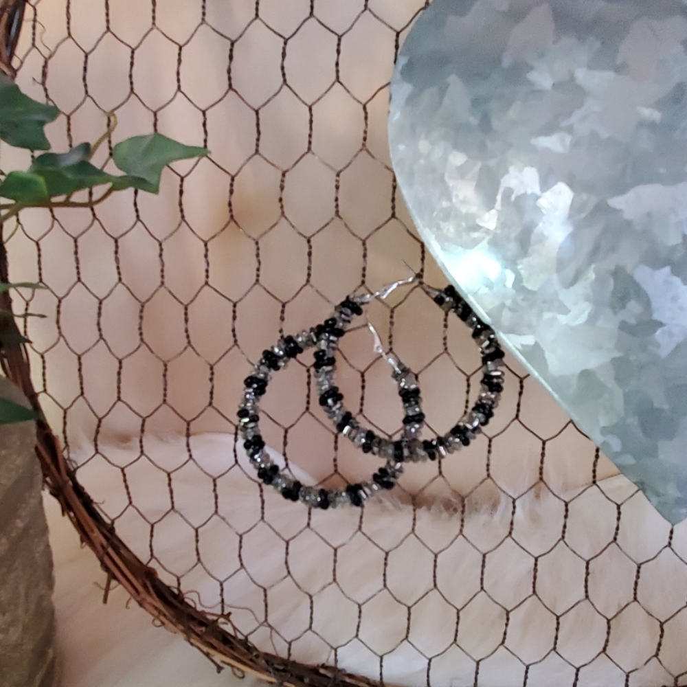 Silver and black beaded hoop earrings.